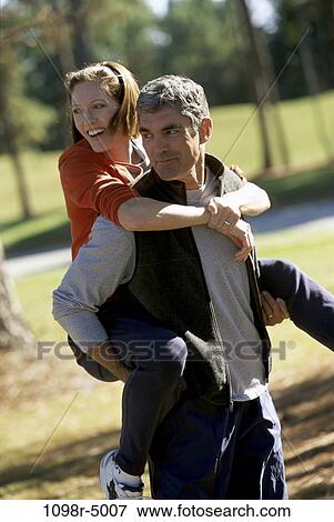 people, couple, Hispanic, outdoors, Middle-aged, romance, piggyback View Large Photo Image Stock Photo - people, couple, Hispanic, outdoors, Middle-aged, romance, piggyback. Fotosearch