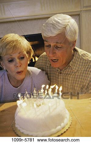 people, couple, senior, cake, birthday, blowing, celebrating View Large Photo Image Stock Image - people, couple, senior, cake, birthday, blowing, celebrating. Fotosearch