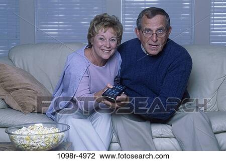 people, couple, senior, popcorn, watch, watching, television View Large Photo Image Stock Image - people, couple, senior, popcorn, watch, watching, television. Fotosearch