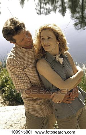 people, couple, sitting, lake, outdoors, romantic, embracing View Large Photo Image Stock Image - people, couple, sitting, lake, outdoors, romantic, embracing. Fotosearch