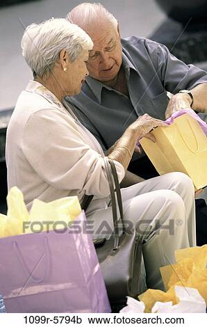 people, couple, sitting, senior, outdoors, looking, shopping View Large Photo Image Stock Image - people, couple, sitting, senior, outdoors, looking, shopping. Fotosearch