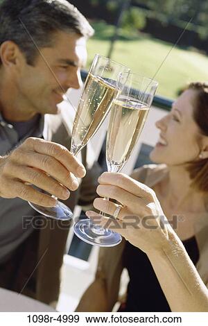 people, couple, toasting, champagne, Hispanic, outdoors, Middle-aged View Large Photo Image Stock Photo - people, couple, toasting, champagne, Hispanic, outdoors, Middle-aged. Fotosearch