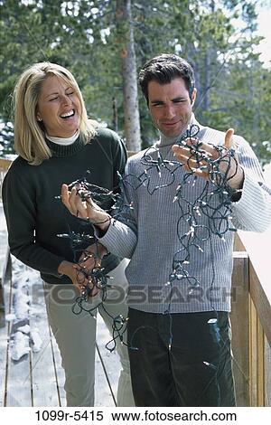 Stock Photography - people, couple, winter, outdoors, Middle-aged, lights, humor. Fotosearch