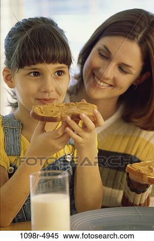 Stock Photography - people, eating, glass, mother, plate, milk, bread. Fotosearch