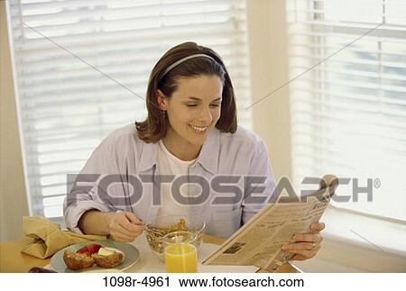 Stock Image - people, eating, woman, morning, newspaper, healthy. Fotosearch