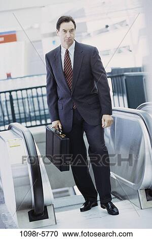 Stock Image - people, escalator, business, Middle-aged, businessman. Fotosearch