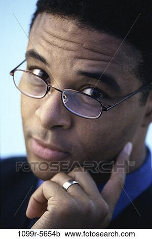 Stock Image - people, eyeglasses, skeptical, business, Middle-aged, businessman. Fotosearch