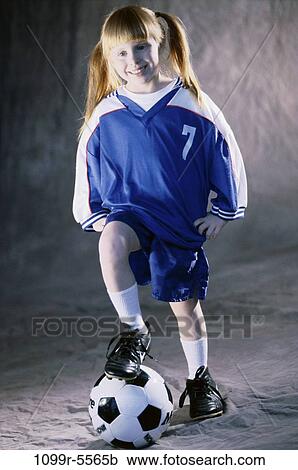 Stock Image - people, girl, child, uniform, indoors, soccer, soccer ball. Fotosearch