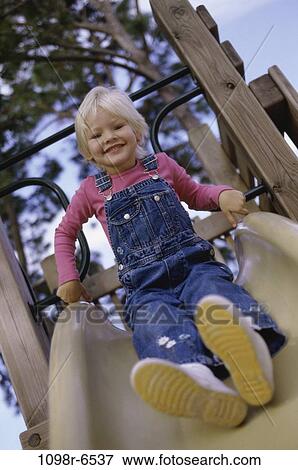 people, girl, sliding, playground, outdoors, child, blond View Large Photo Image Stock Photo - people, girl, sliding, playground, outdoors, child, blond. Fotosearch