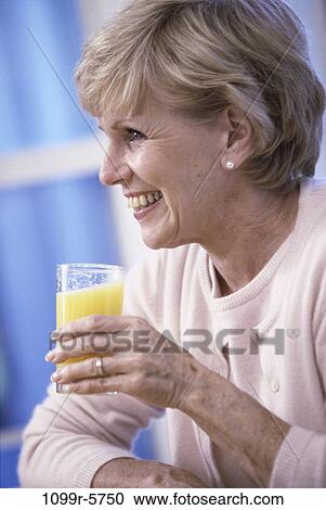 Stock Image - people, glass, home, woman, smiling, profile, healthy. Fotosearch