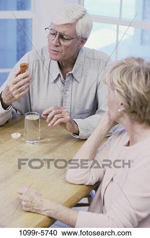 Stock Image - people, glass, water, table, couple, sitting, senior. Fotosearch