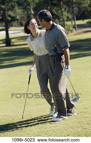 Stock Image - people, golf, couple, Hispanic, outdoors, Middle-aged, brunette. Fotosearch