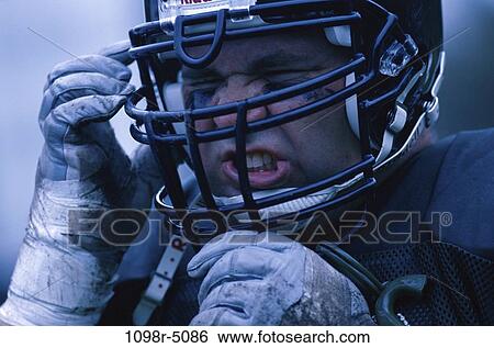 Stock Photograph - people, helmet, football, outdoors, player, sport. Fotosearch