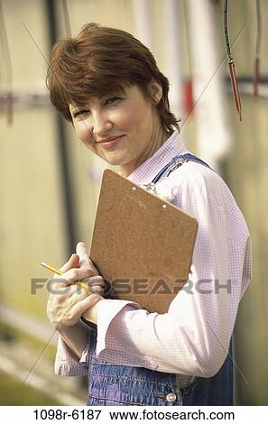 people, industry, woman, holding, clipboard, outdoors, Middle-aged View Large Photo Image Stock Photo - people, industry, woman, holding, clipboard, outdoors, Middle-aged. Fotosearch