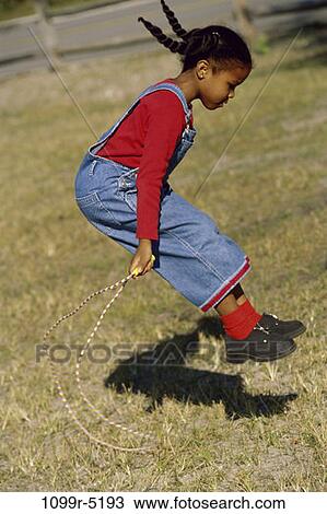 Stock Image - people, jump, jumping, girl, outdoors, child, African-American. Fotosearch