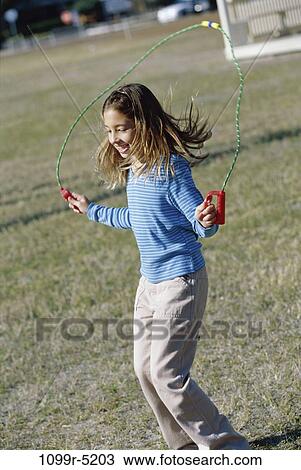 Stock Image - people, jump, jumping, girl, outdoors, child, brunette. Fotosearch