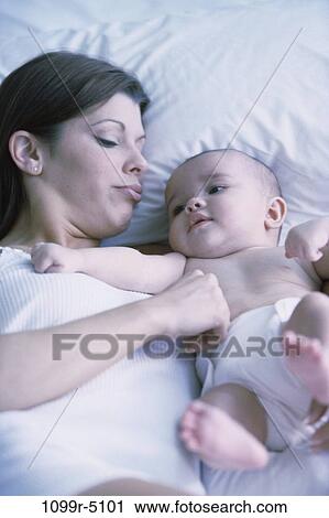 people, mother, bed, family, brunette, careful, parent View Large Photo Image Stock Image - people, mother, bed, family, brunette, careful, parent. Fotosearch