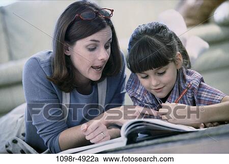 Stock Image - people, mother, homework, studying, writing, family, daughter. Fotosearch