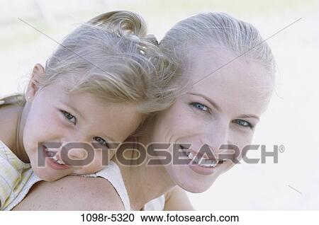 Stock Image - people, mother, outdoors, family, blond, affection, daughter. Fotosearch