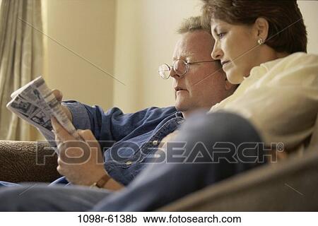 Stock Image - people, newspaper, couple, eyeglasses, reading, Middle-aged, brunette. Fotosearch