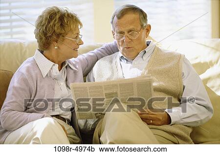 Stock Image - people, newspaper, couple, senior, reading, indoors, Caucasian. Fotosearch