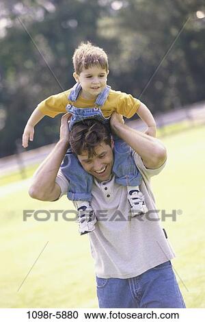 people, outdoors, carrying, family, father, brunette View Large Photo Image Stock Image - people, outdoors, carrying, family, father, brunette. Fotosearch