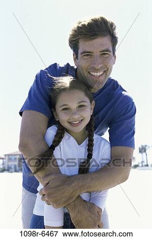 people, outdoors, hugging, family, hug, father, daughter View Large Photo Image Stock Photo - people, outdoors, hugging, family, hug, father, daughter. Fotosearch