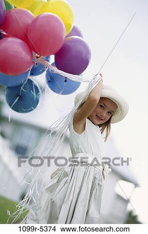 Picture - people, party, formal, hat, balloons, holding, girl. Fotosearch