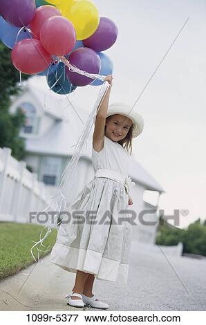Stock Photo - people, party, formal, hat, balloons, holding, girl. Fotosearch