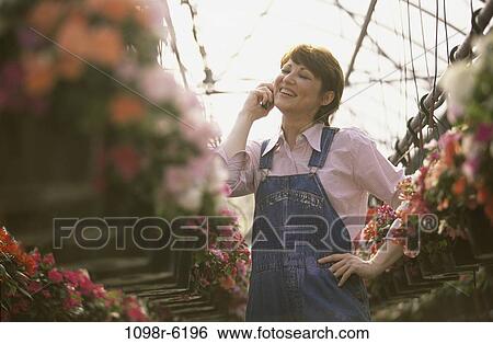 Stock Photograph - people, plants, industry, woman, talking, phone, flowers. Fotosearch