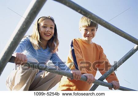 Stock Image - people, playing, climbing, outdoors, children, play, monkey bars. Fotosearch