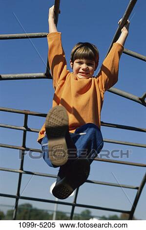 Stock Photography - people, playing, hanging, jungle gym, boy, outdoors, child. Fotosearch