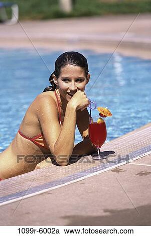 Stock Image - people, pool, woman, drinking, outdoors, alcoholic, vacation. Fotosearch