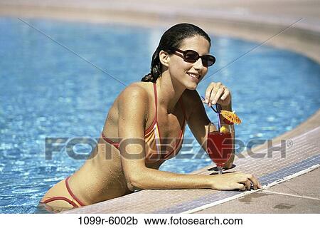 Stock Image - people, pool, woman, drinking, sunglasses, outdoors, alcoholic. Fotosearch