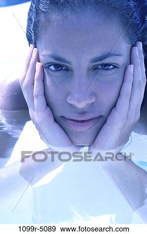 Stock Photo - people, pool, woman, Hispanic, outdoors, brunette, headshot. Fotosearch