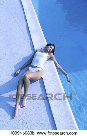 Stock Image - people, pool, woman, outdoors, brunette, clothed, Caucasian. Fotosearch