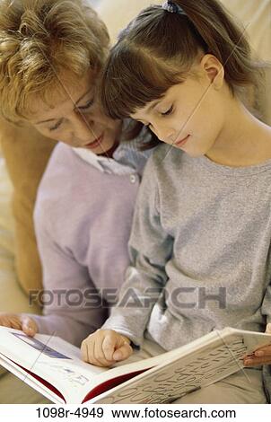 people, reading, family, granddaughter, indoors, grandmother, grandparent View Large Photo Image Stock Photo - people, reading, family, granddaughter, indoors, grandmother, grandparent. Fotosearch