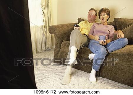 Stock Image - people, smiling, couple, eyeglasses, sitting, watch. Fotosearch