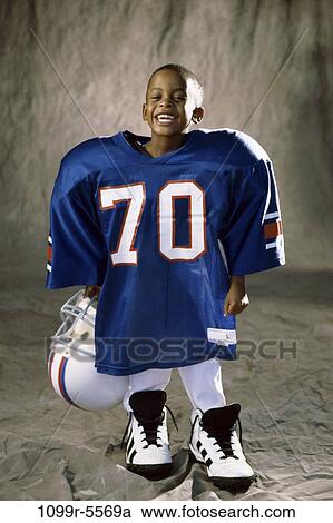 Stock Image - people, smiling, helmet, football, boy, future, goals. Fotosearch