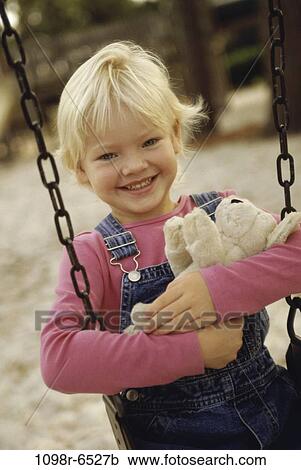 Stock Image - people, stuffed animal, holding, girl, swing, playground, outdoors. Fotosearch
