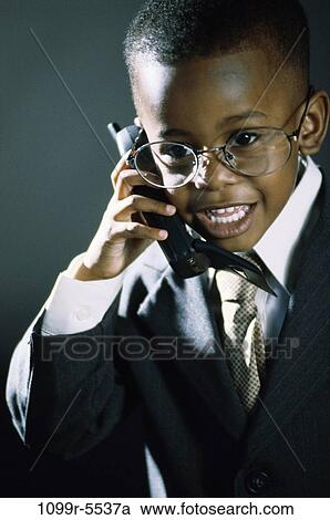 Stock Image - people, suit, talking, eyeglasses, phone, boy, business. Fotosearch