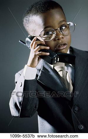 Stock Image - people, suit, talking, eyeglasses, phone, boy, business. Fotosearch