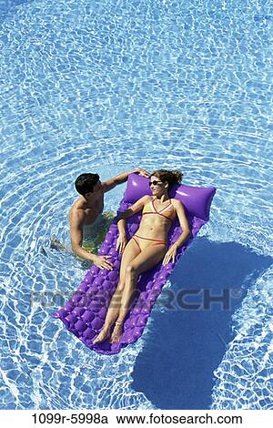 people, swim, floating, pool, couple, swimming, raft View Large Photo Image Stock Image - people, swim, floating, pool, couple, swimming, raft. Fotosearch
