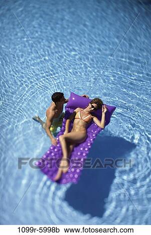 people, swim, floating, pool, couple, swimming, raft View Large Photo Image Stock Image - people, swim, floating, pool, couple, swimming, raft. Fotosearch