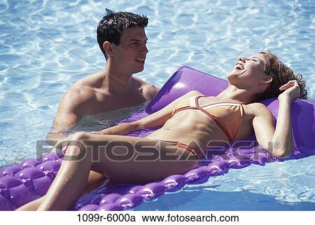 people, swim, floating, pool, couple, swimming, laughing View Large Photo Image Stock Image - people, swim, floating, pool, couple, swimming, laughing. Fotosearch