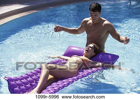 people, swim, floating, pool, couple, swimming, splash View Large Photo Image Stock Photograph - people, swim, floating, pool, couple, swimming, splash. Fotosearch