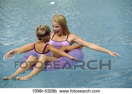 Stock Image - people, swim, floating, pool, mother, swimming, family. Fotosearch