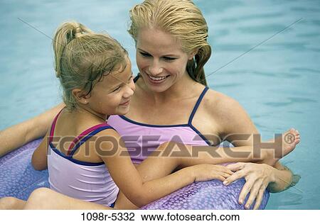 Stock Image - people, swim, floating, pool, mother, swimming, outdoors. Fotosearch