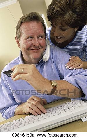 Stock Image - people, telephone, couple, phone, Middle-aged, shopping, shop. Fotosearch