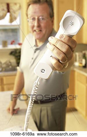Stock Image - people, telephone, phone, holding, Middle-aged, hold. Fotosearch